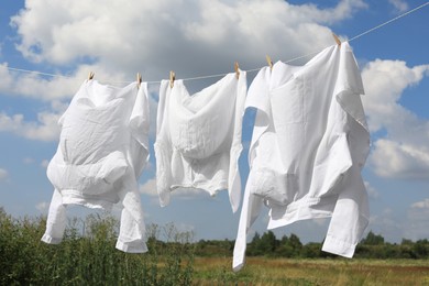 Clean clothes hanging on washing line outdoors. Drying laundry
