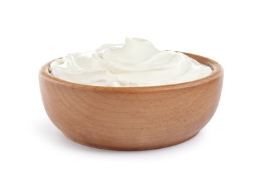 Wooden bowl with fresh sour cream isolated on white