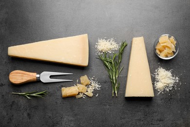 Flat lay composition with delicious Parmesan cheese on dark grey table