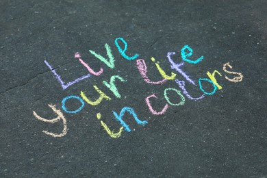 Phrase Live Your Life In Colors written on asphalt