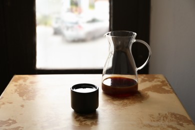 Photo of Aromatic coffee on light brown table in cafe
