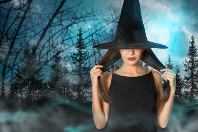 Witch and misty forest under full moon on Halloween