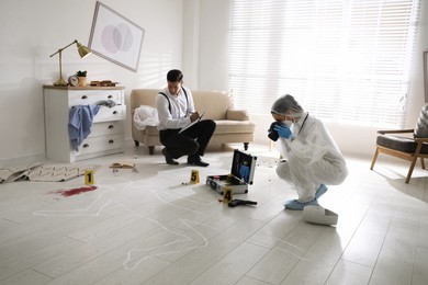 Investigators working at crime scene in living room