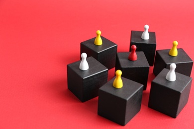 Black blocks with playing pieces on red background, space for text. Roles and responsibility concept
