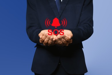 Man holding virtual icon SOS on color background, closeup