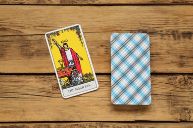 The Magician and other tarot cards on wooden table, flat lay