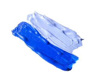 Samples of blue paint on white background, top view
