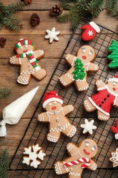 Delicious Christmas cookies and fir branches on wooden table, flat lay