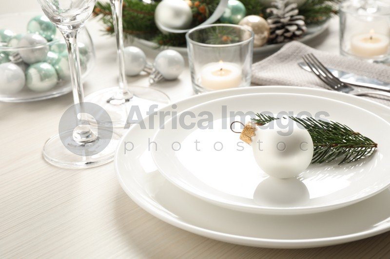 Festive table setting with beautiful dishware and Christmas decor on white wooden background