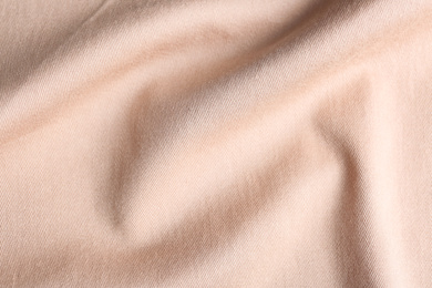 Texture of light pink fabric as background, closeup
