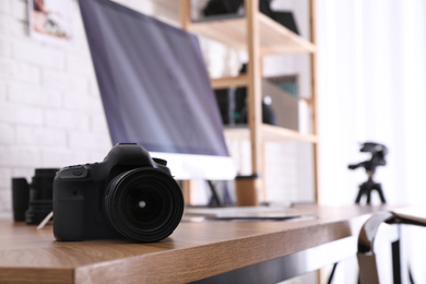 Photo of Photographer's workplace with professional camera in office