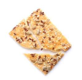 Broken delicious crispy cracker with seeds on white background, top view