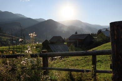 Morning sun shining over village in mountains