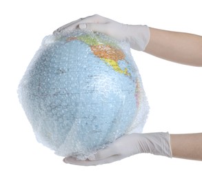 Woman holding globe in bubble wrap on white background, closeup. Environmental protection concept