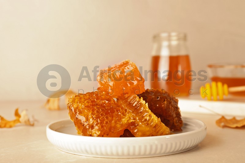 Photo of Plate with fresh tasty honeycombs on table