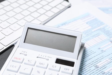 Calculator, document and keyboard on black table, closeup. Tax accounting