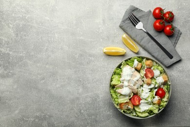 Photo of Delicious salad with Chinese cabbage, cucumber, meat and tomatoes served on grey table, flat lay. Space for text
