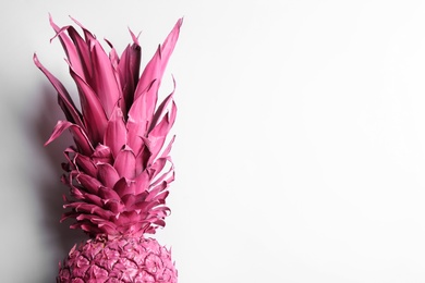 Photo of Painted pink pineapple on white background, top view. Creative concept