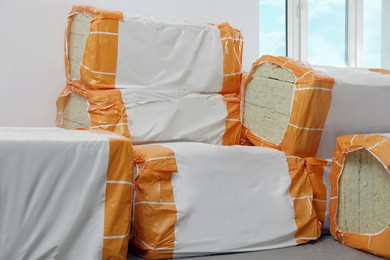 Packages of thermal insulation material in room