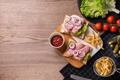 Delicious sandwiches served on wooden table, flat lay. Space for text