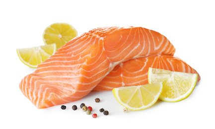 Fresh raw salmon with pepper, lime and lemon on white background. Fish delicacy