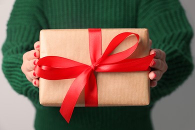 Christmas present. Woman holding gift box, closeup