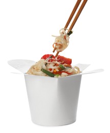 Eating vegetarian wok noodles with chopsticks from box isolated on white