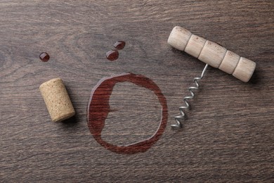 Wine stain, corkscrew and stopper on wooden table, flat lay