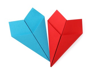 Photo of Handmade light blue and red paper planes isolated on white, top view