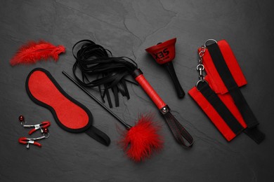 Photo of Sex toys and accessories on black background, flat lay