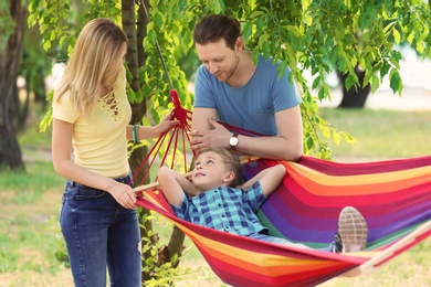 Happy couple with son spending time together outdoors