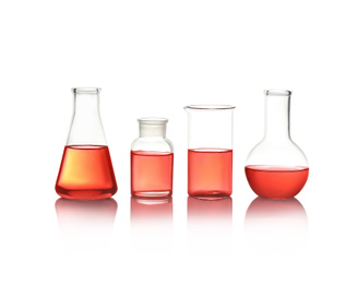Different laboratory glassware with red liquid isolated on white