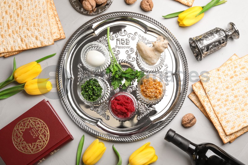 Flat lay composition with symbolic Passover (Pesach) items on color background