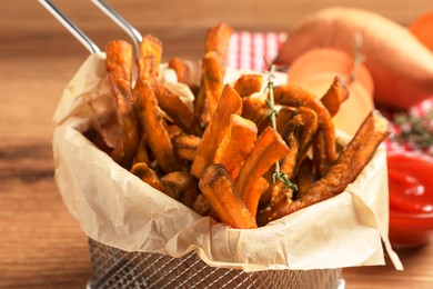 Photo of Sweet potato fries on wooden table, closeup