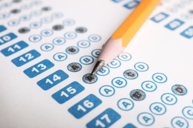 Photo of Pencil on answer sheet, closeup. Student passing exam