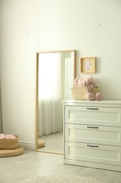 Photo of Modern room interior with white chest of drawers