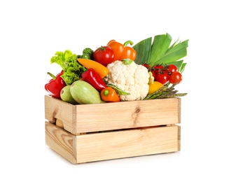 Photo of Wooden crate with fresh vegetables on white background