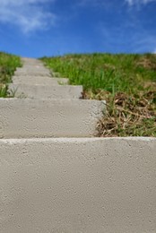 Outdoor concrete staircase up to hill, low angle view