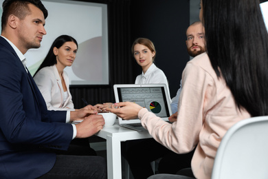 Business people having meeting in conference room with video projection screen