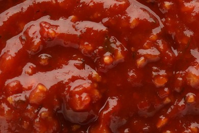 Photo of Texture of delicious adjika sauce as background, closeup