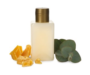 Bottle of cosmetic product, natural beeswax and eucalyptus on white background
