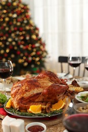 Festive dinner with delicious baked turkey served on table indoors. Christmas celebration
