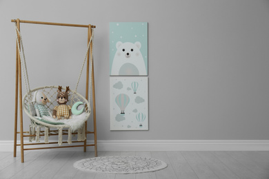 Stylish child's room interior with adorable paintings and hanging chair. Space for text