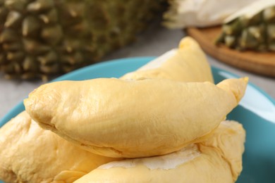 Pieces of fresh ripe durian on plate, closeup