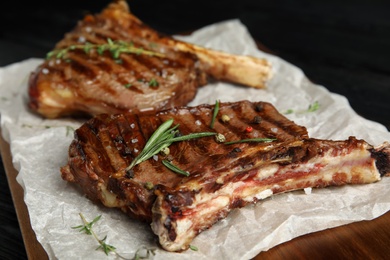 Tasty grilled meat steaks on board, closeup