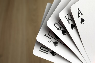 Playing cards with royal flush combination, closeup. Space for text