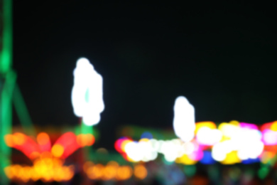 Blurred view of city street with festive lights at night. Bokeh effect