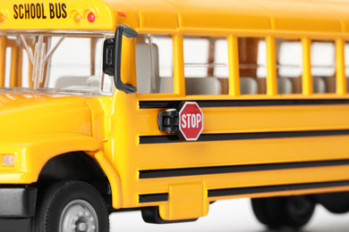 Yellow school bus on white background, closeup. Transport for students