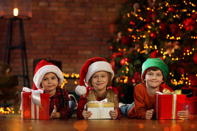 Little children with Christmas gifts at home. Presents from Santa Claus