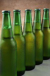 Photo of Many bottles of beer on white table, closeup